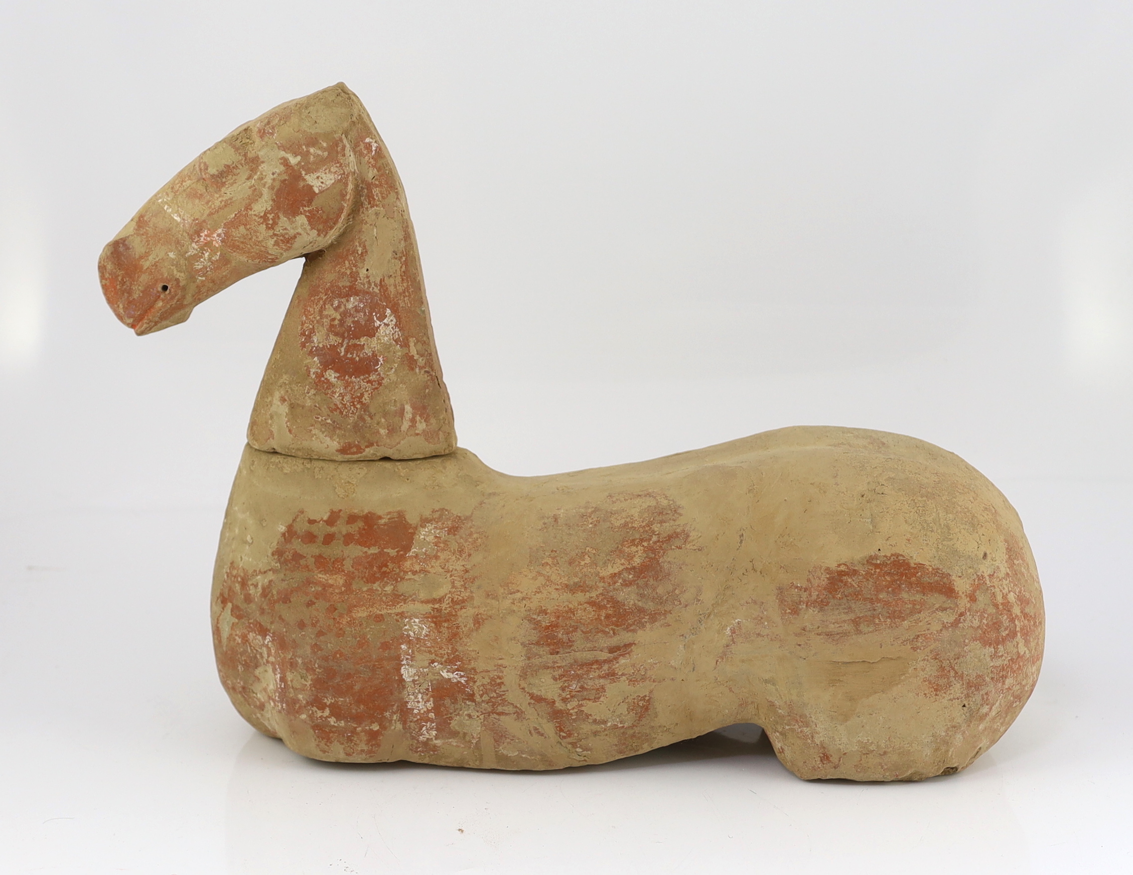 A Chinese buff pottery model of a horse, Han dynasty (206 BC-220 AD)